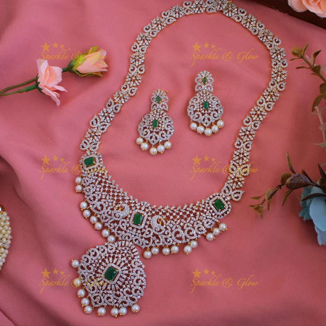 Satement Peacock floral design American diamond long necklace with emerald and pearl drops - Sparkle and Glow
