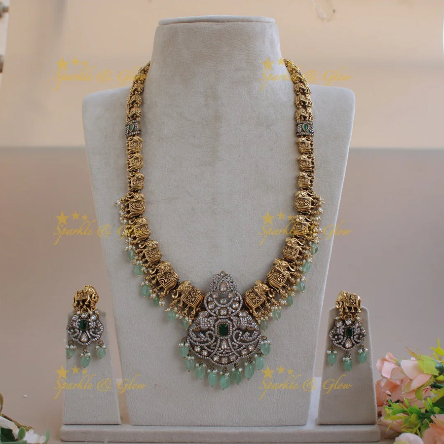Statement Elephant carved gold and black finish Victorian AD long necklace with mint green beads - Sparkle and Glow