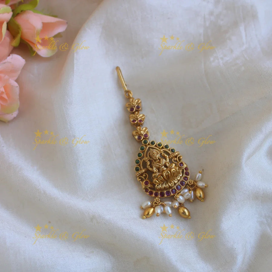 Gold alike Lakshmi carved maang tikka with ruby emerald and rice pearl drops - Sparkle and Glow