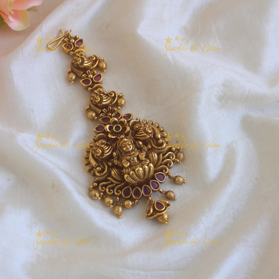 Elegant Lakshmi peacock carved maang tikka with ruby and gold beads - Sparkle and Glow