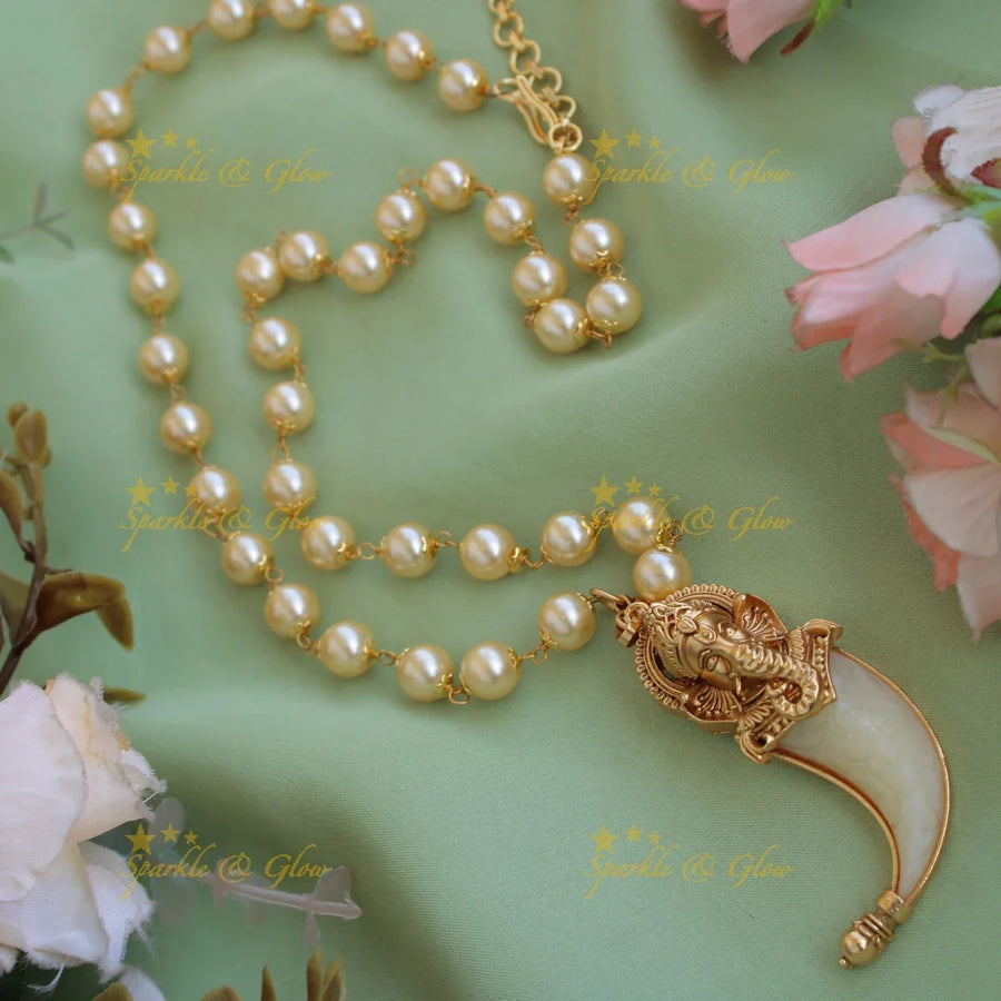 Elegant Ganesha carved single Puliguru pendent with pearl chain - Sparkle and Glow