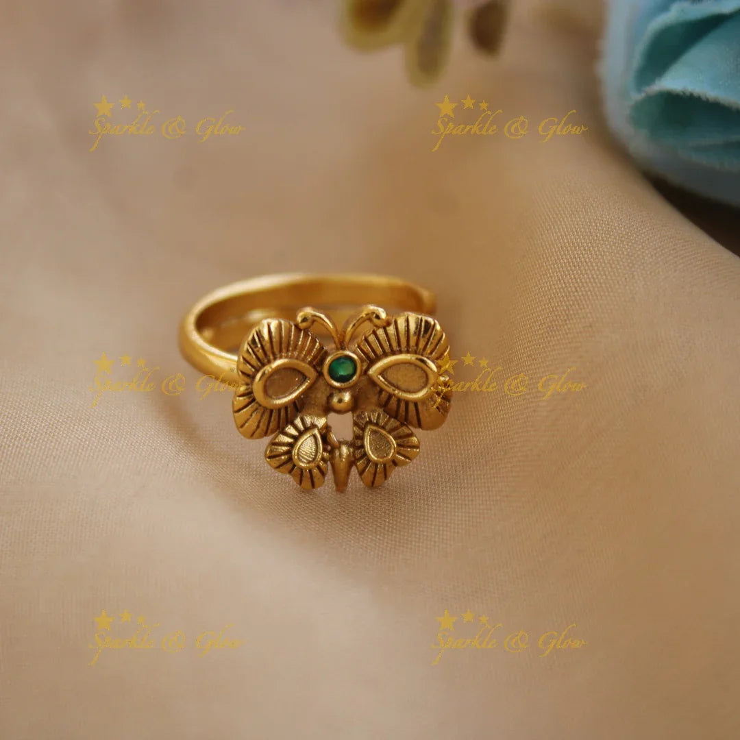 Gold alike Butterfly design finger ring , with emerald - Sparkle and Glow