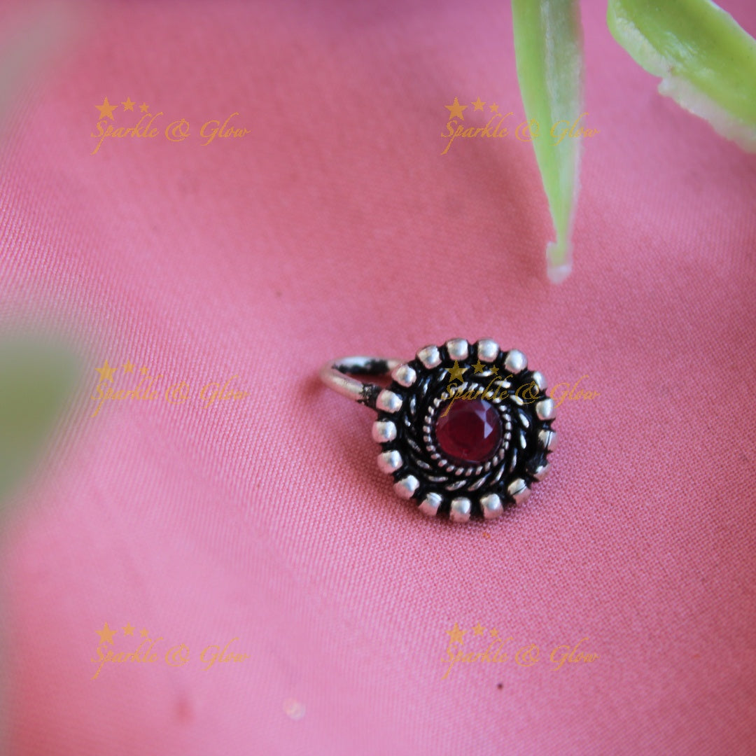 Stunning oxidised silver round shape nose pin with ruby