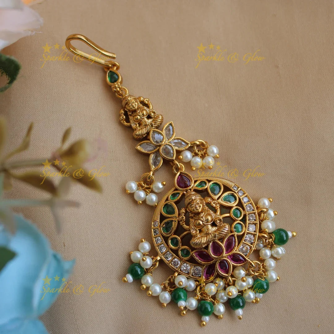 Elegant Lakshmi lotus moon design maang tikka with ruby emerald pearls and green beads - Sparkle and Glow