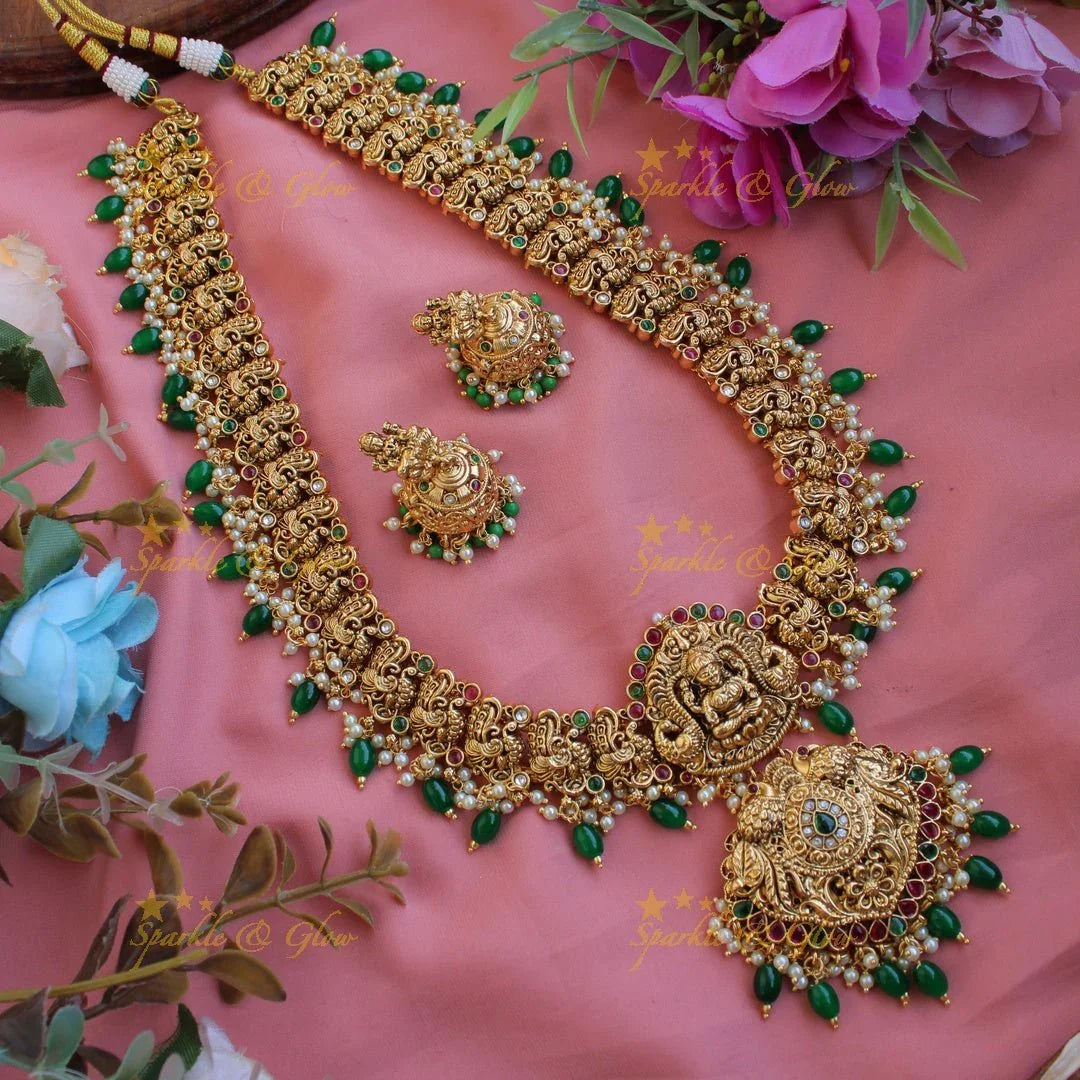 Grand gold alike Lakshmi peacock carved gutta pusalu long necklace with ruby emerald and green beads - Sparkle and Glow