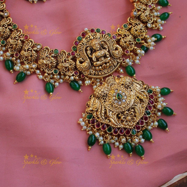 Grand gold alike Lakshmi peacock carved gutta pusalu long necklace with ruby emerald and green beads - Sparkle and Glow