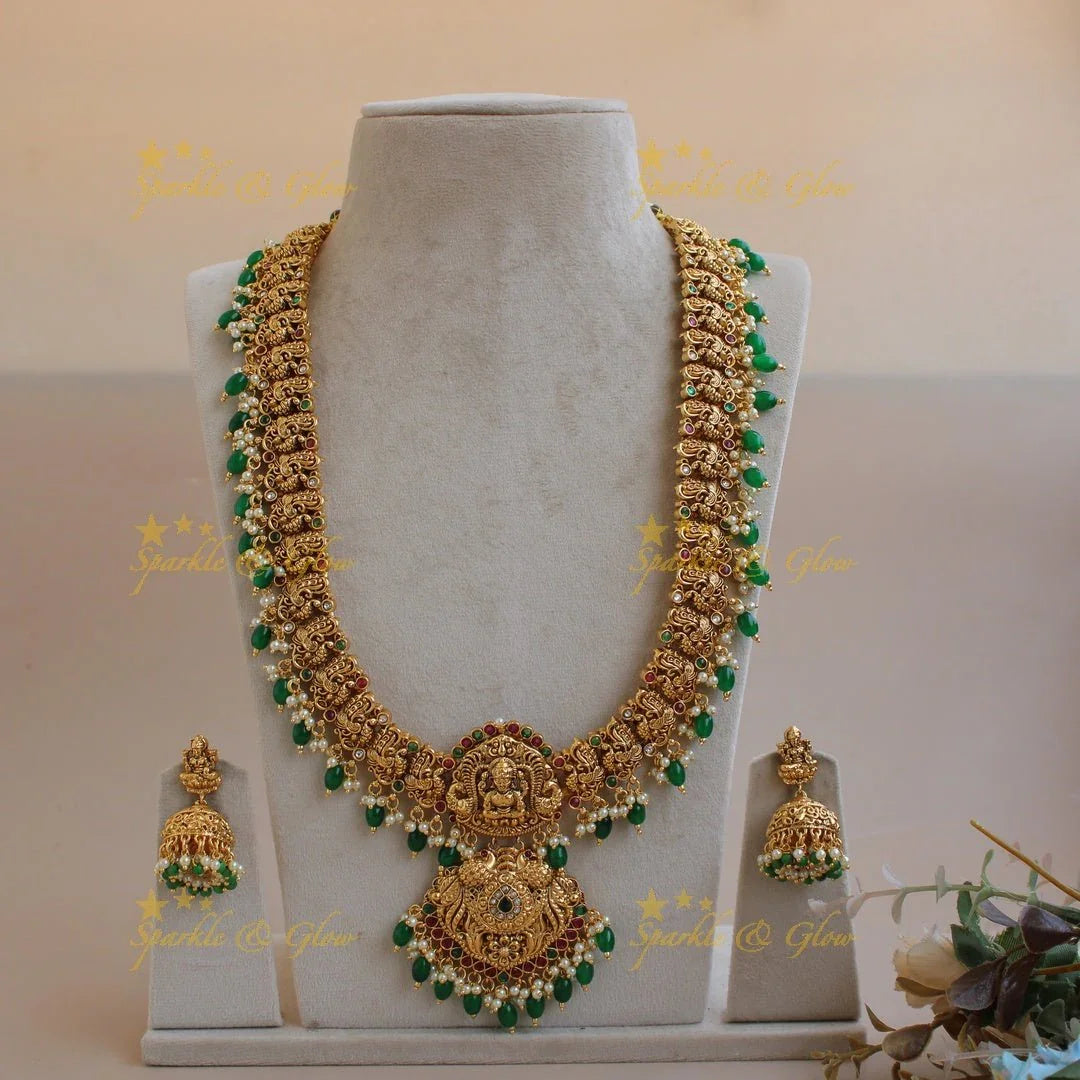 Grand gold alike Lakshmi peacock carved gutta pusalu long necklace with ruby emerald and green beads - Sparkle and Glow