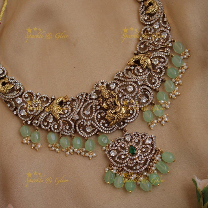 Exclusive Lakshmi peacock carved floral dual tone victorian AD short necklace with purple beads - Sparkle and Glow