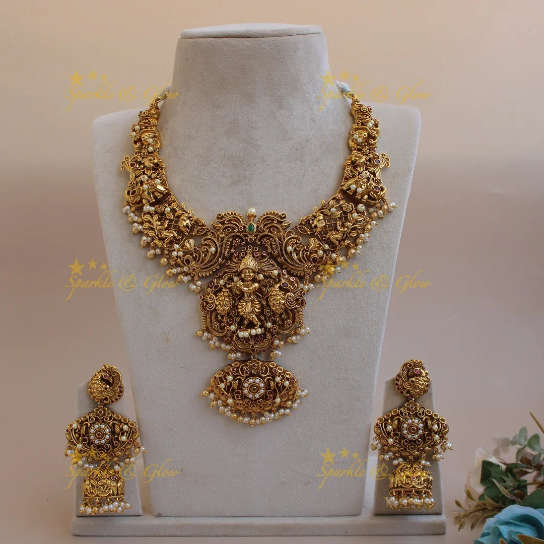Grand intricate Krishna playing flute and peacock carved short necklace with pearls and gold beads - Sparkle and Glow