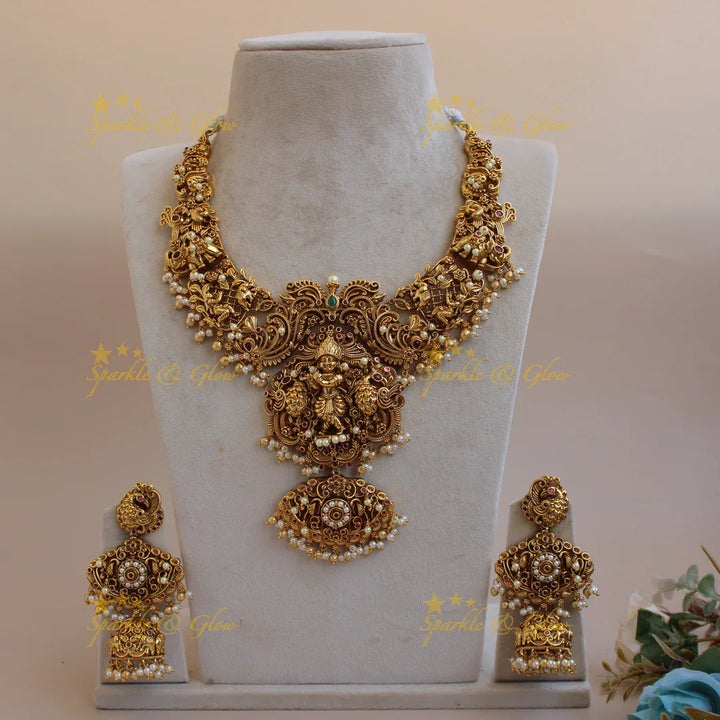 Grand intricate Krishna playing flute and peacock carved short necklace with pearls and gold beads - Sparkle and Glow