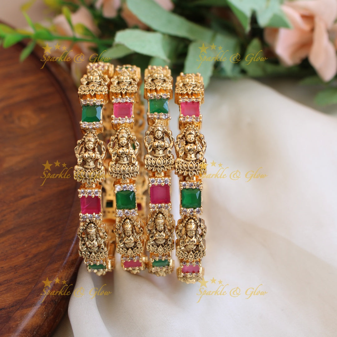 Gold alike Lakshmi carved stone bangles with ruby emerald and white stones a pair, 2.4