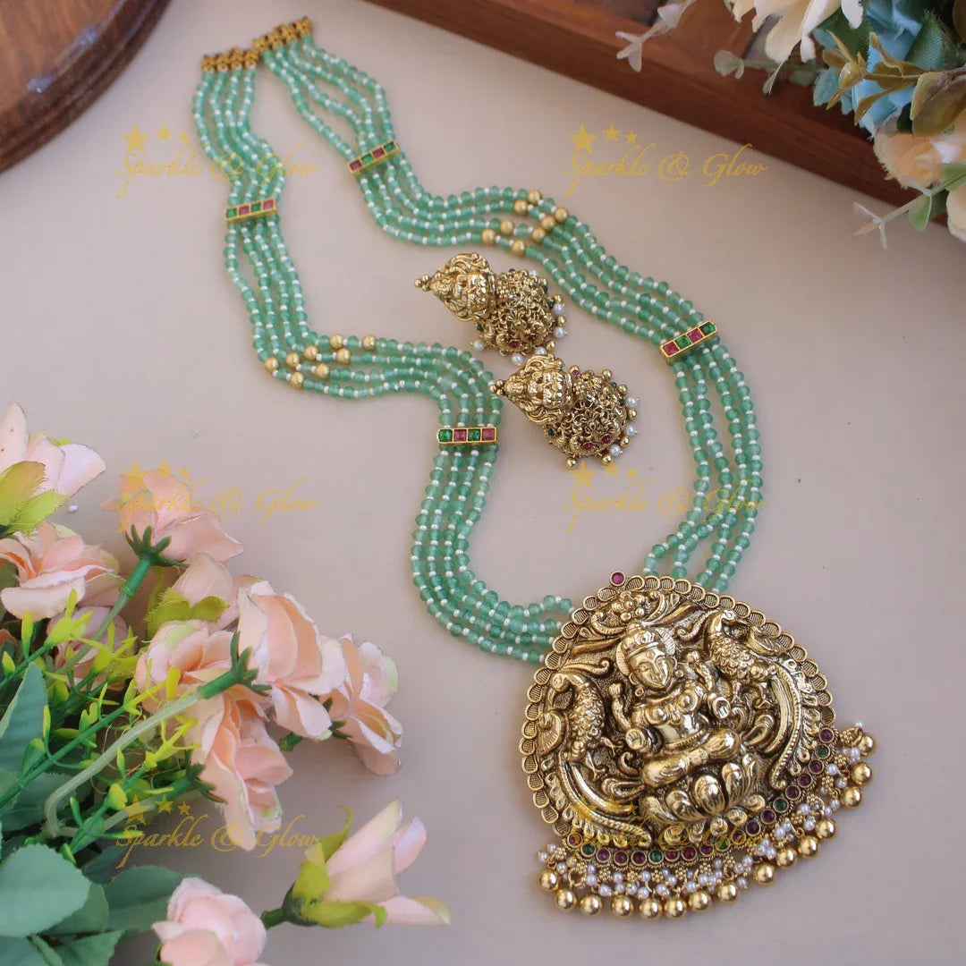 Grand Lakshmi peacock pendant four layer mint green beads haram with pearls and gold beads - Sparkle and Glow