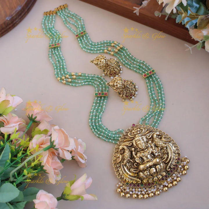 Grand Lakshmi peacock pendant four layer mint green beads haram with pearls and gold beads - Sparkle and Glow