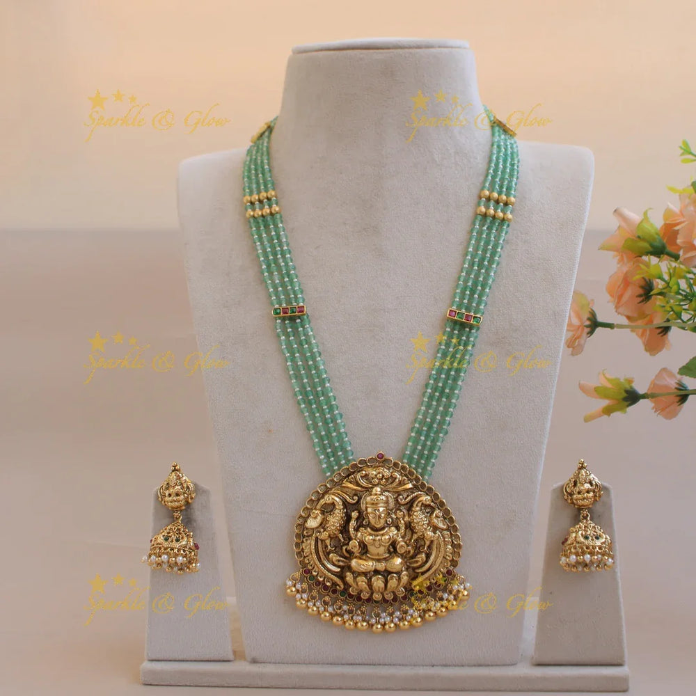Grand Lakshmi peacock pendant four layer mint green beads haram with pearls and gold beads - Sparkle and Glow