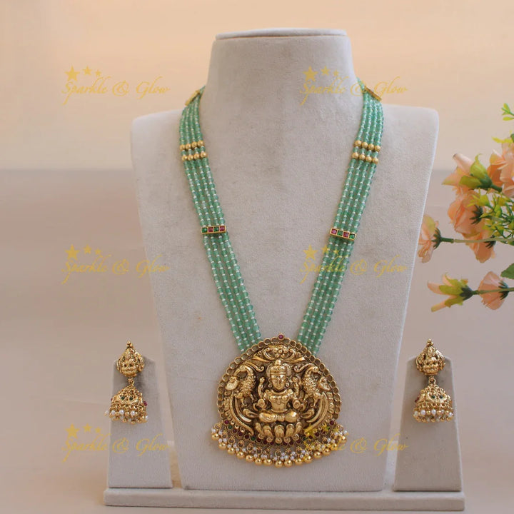 Grand Lakshmi peacock pendant four layer mint green beads haram with pearls and gold beads - Sparkle and Glow
