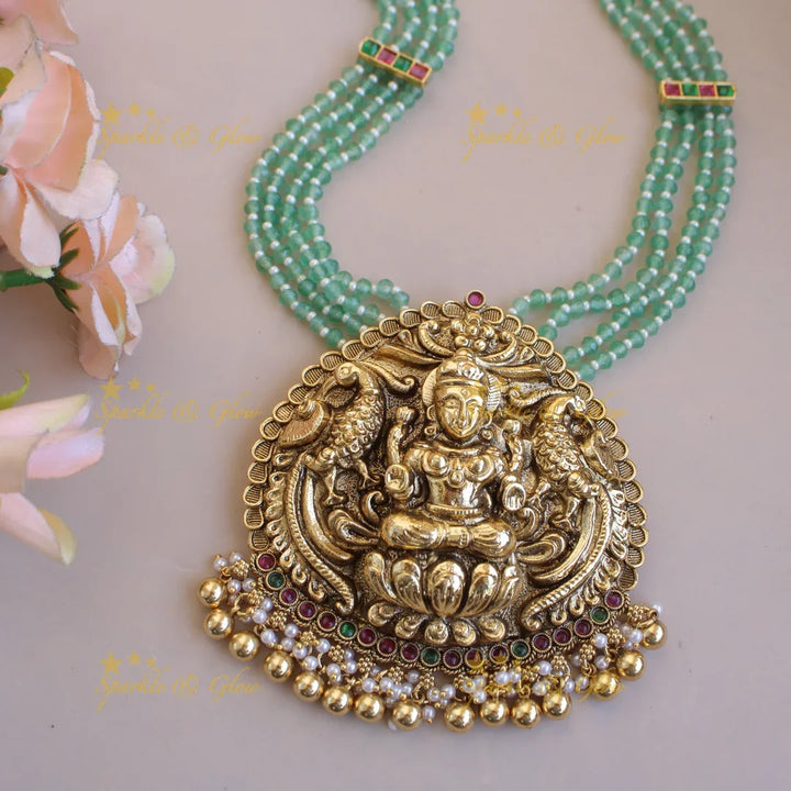 Grand Lakshmi peacock pendant four layer mint green beads haram with pearls and gold beads - Sparkle and Glow