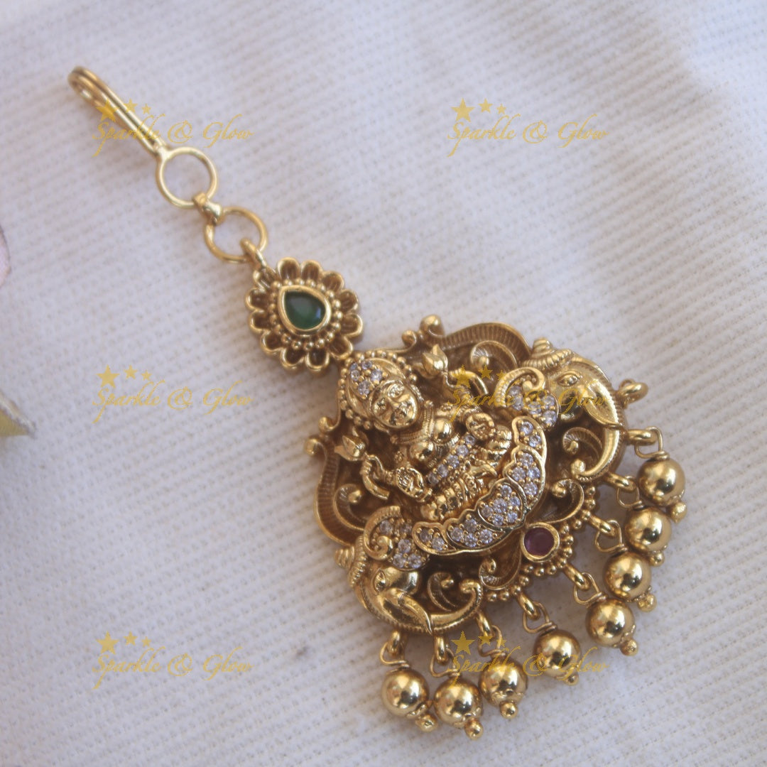 Elegant gold alike lakshmi with some AD and gold beads maang tikka