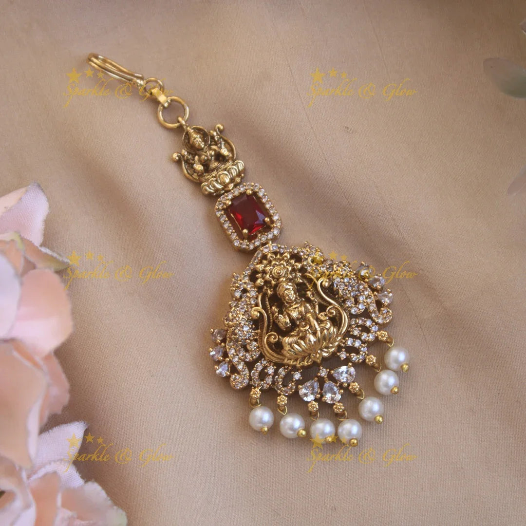 Beautiful Lakshmi flower carved maang tikka with ruby CZ stones and pearl drops - Sparkle and Glow