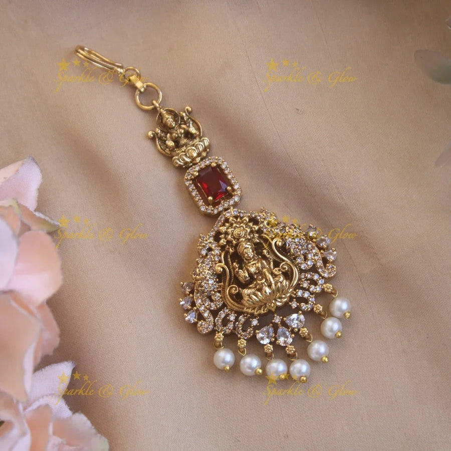 Beautiful Lakshmi flower carved maang tikka with ruby CZ stones and pearl drops - Sparkle and Glow