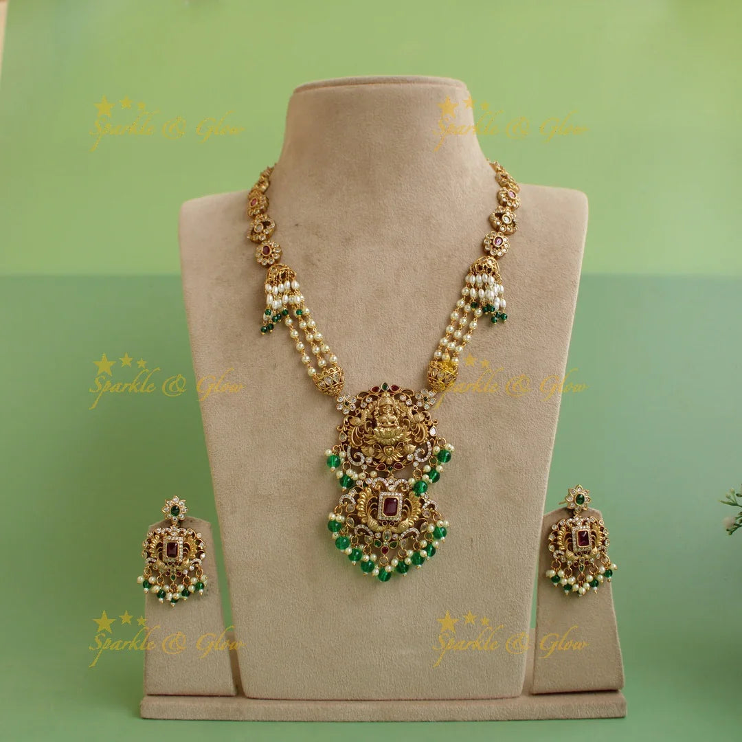 Grand intricate Lakshmi peacock carved long necklace with ruby emerald white stones pearls and green beads - Sparkle and Glow