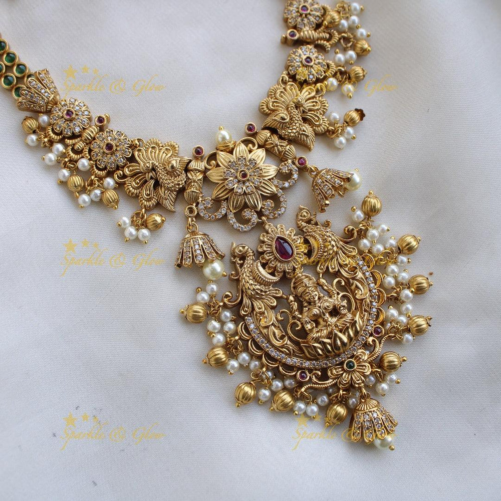 Premium Matt Lakshmi peacock flower carved short necklace with ruby emerald CZ stones pearls and gold beads - Sparkle and Glow