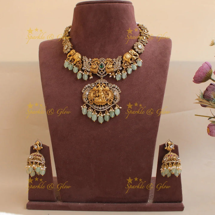 Elegant Lakshmi elephant and peacock carved dual tone Victorian AD short necklace with mint green beads - Sparkle and Glow