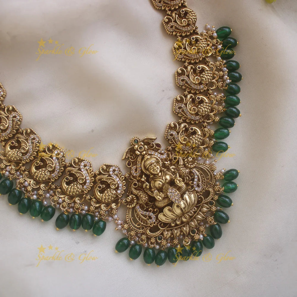 Stunning Lakshmi Peacock carved long necklace with CZ stones and green beads - Sparkle and Glow