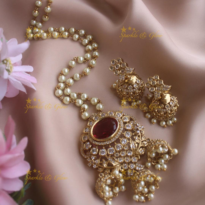 Elegant Floral and ruby stone pendant haram with pearl chain and jhumuka drops - Sparkle and Glow