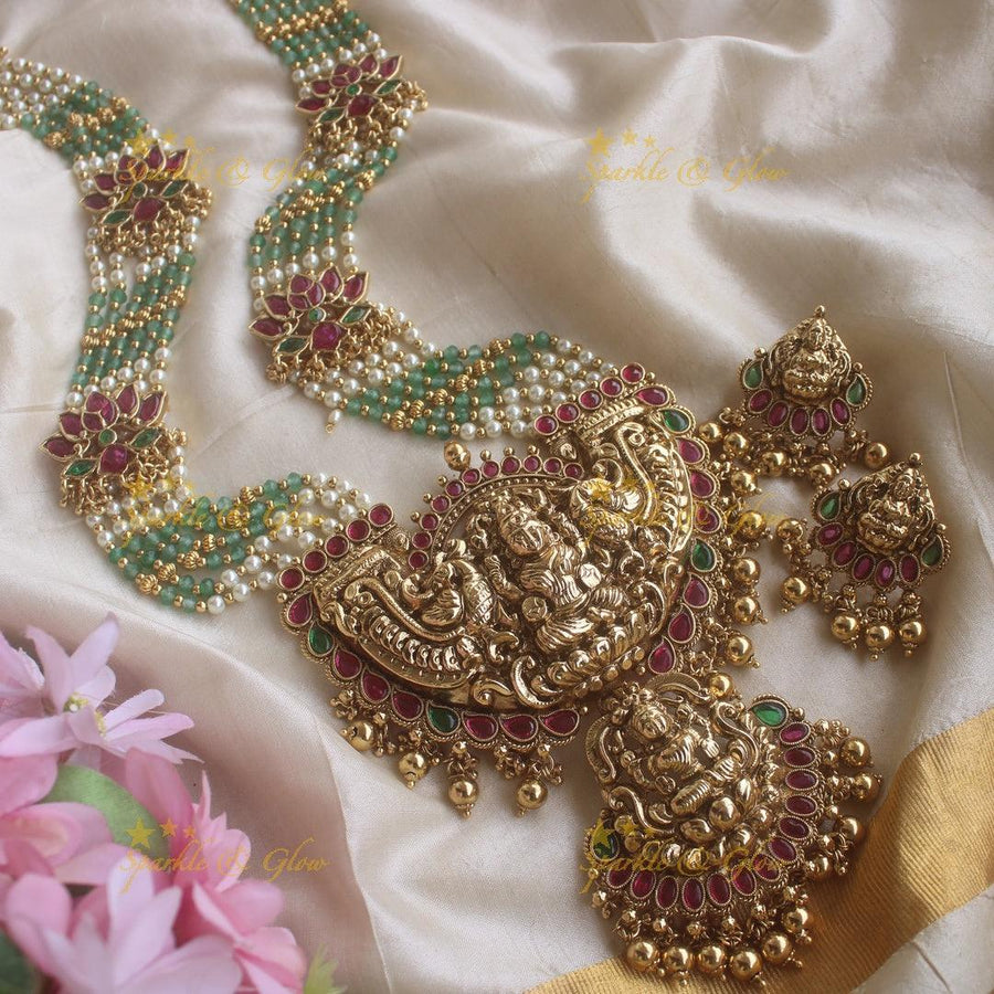 Stunning Lakshmi pendant lotus design haram with multi layer pearl and mint green beads chain - Sparkle and Glow