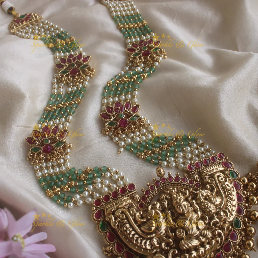 Stunning Lakshmi pendant lotus design haram with multi layer pearl and mint green beads chain - Sparkle and Glow