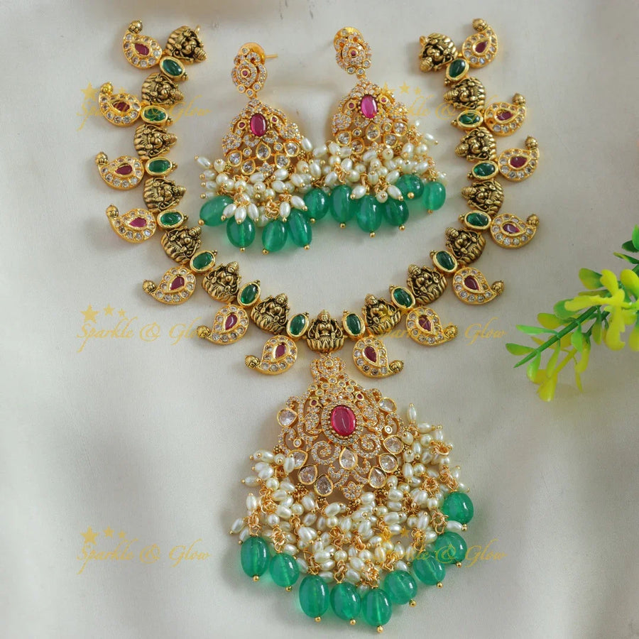 Elegant Lakshmi mango design AD short necklace with ruby emerald rice pearls and green beads - Sparkle and Glow