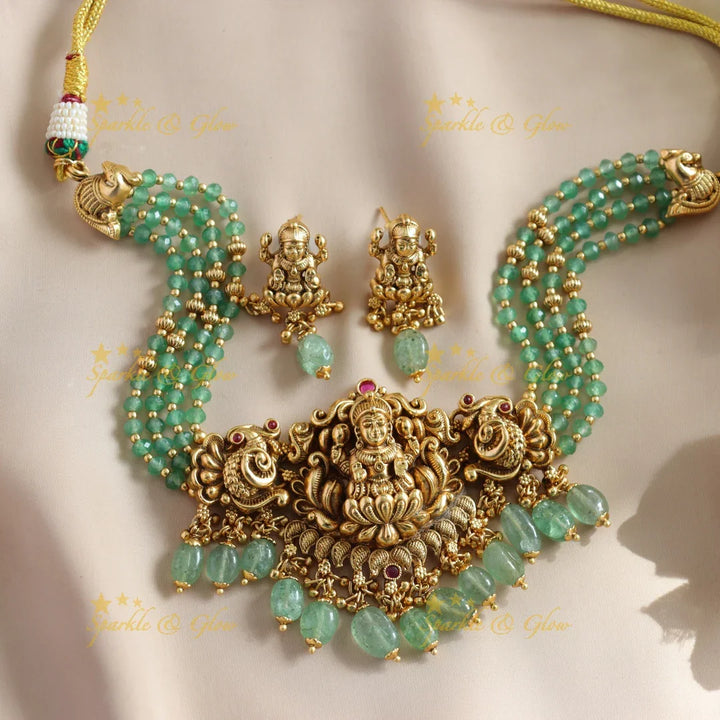 Beautiful Lakshmi Peacock carved choker with multi layer gold and mint green beads - Sparkle and Glow