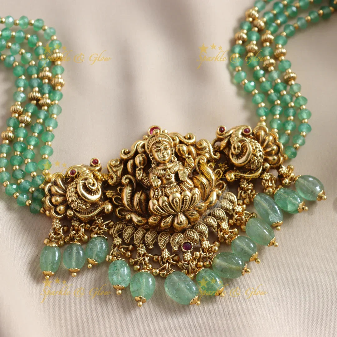 Beautiful Lakshmi Peacock carved choker with multi layer gold and mint green beads - Sparkle and Glow