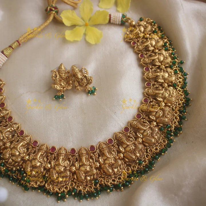 Elegant Ganesha carved short necklace with ruby stones and green beads - Sparkle and Glow