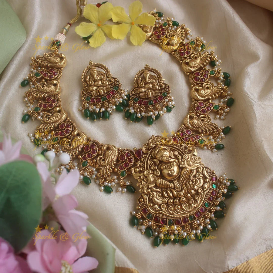 Grand Intricate Ganesha peacock carved short necklace with ruby emerald stones pearls and green beads - Sparkle and Glow