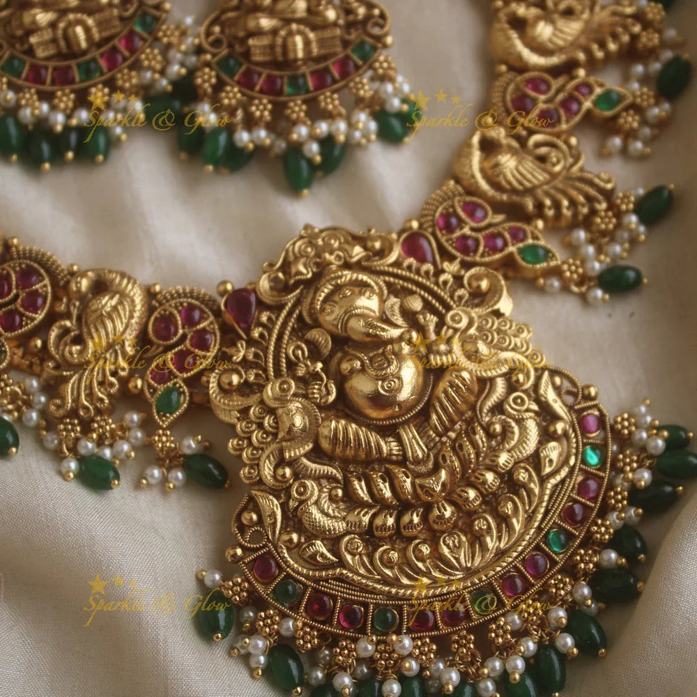 Grand Intricate Ganesha peacock carved short necklace with ruby emerald stones pearls and green beads - Sparkle and Glow