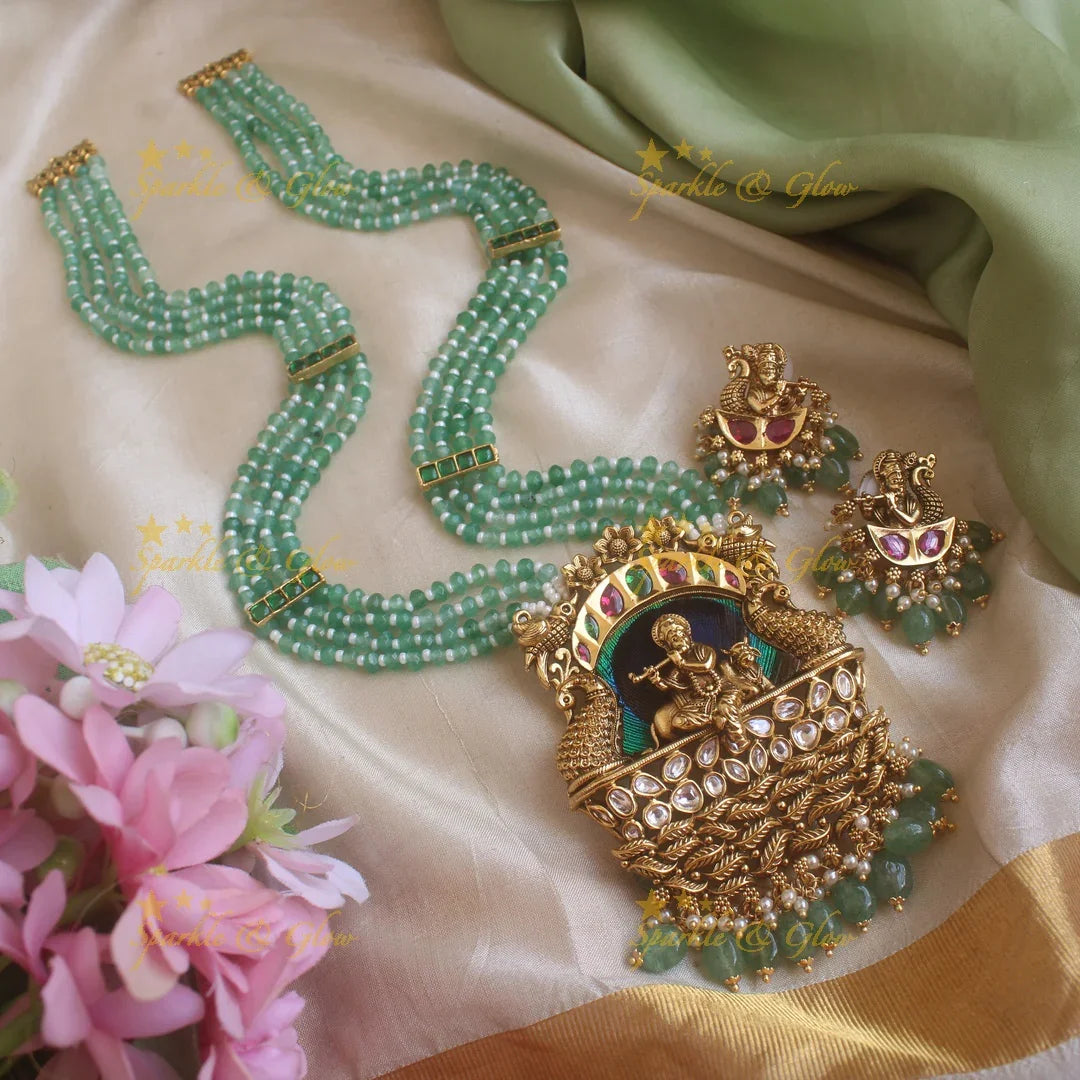 Statement Krishna Playing flute and peacock carved pendant haram with multi layer mint green beads chain and stones - Sparkle and Glow