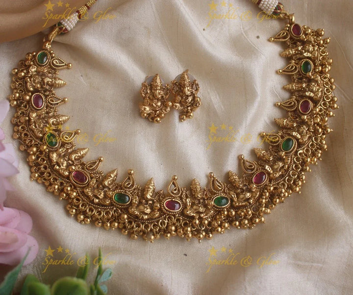 Elegant Idol Ganesha and Leaf design short necklace with gold beads - Sparkle and Glow