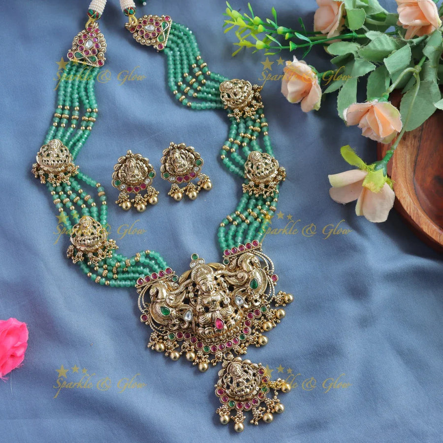 Gorgeous Lakshmi peacock carved pendant haram with multi layer gold and mint green beads - Sparkle and Glow