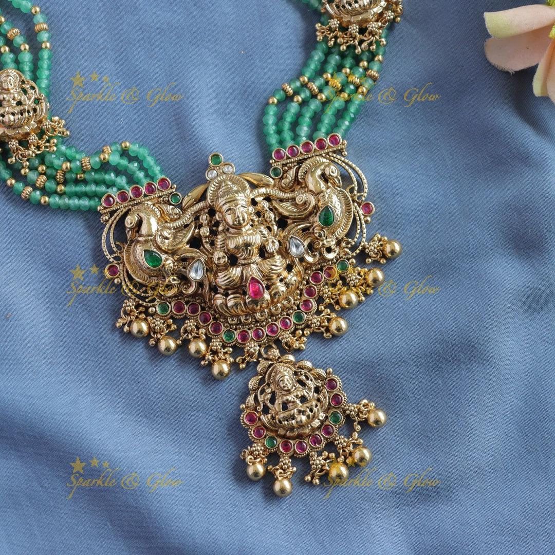 Gorgeous Lakshmi peacock carved pendant haram with multi layer gold and mint green beads - Sparkle and Glow