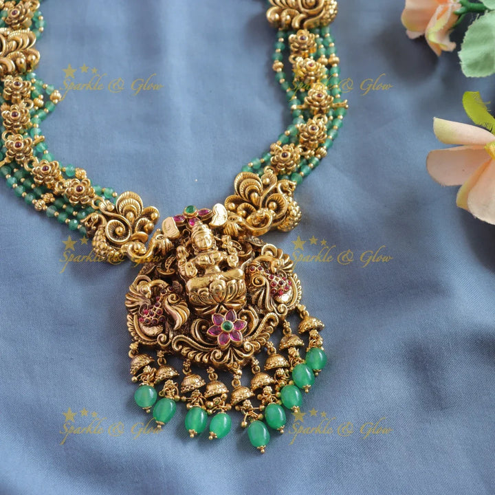 Elegant Lakshmi peacock floral design haram with multi layer gold and mint green beads - Sparkle and Glow