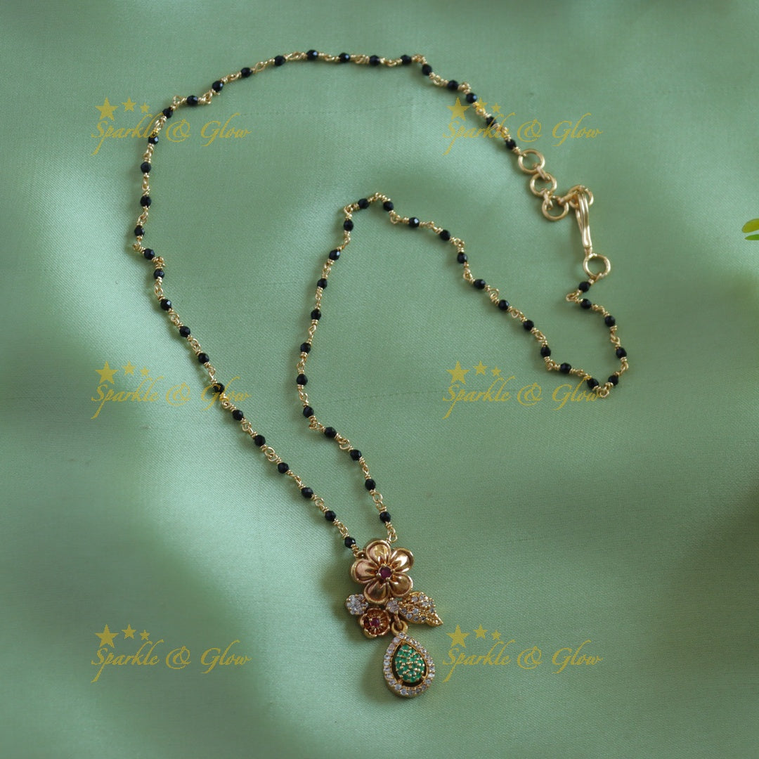 Stunning Floral leaf design pendant black beads chain , mangalsutra with ruby and emeralds