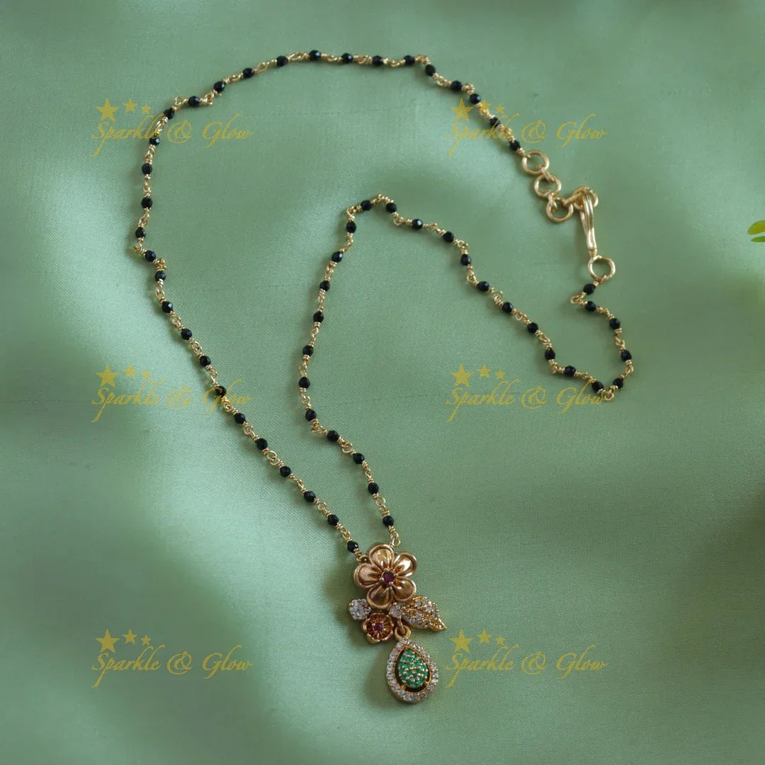Stunning Floral leaf design pendant black beads chain , mangalsutra with ruby and emeralds - Sparkle and Glow