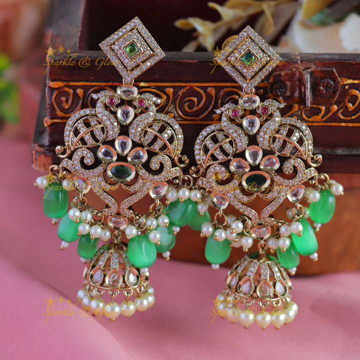 Gracious Dual tone Peacock carved Victorian AD earrings with jhumuka hanging - Sparkle and Glow