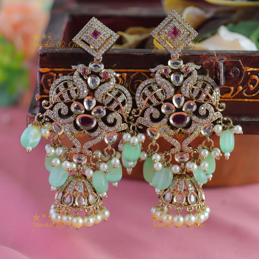 Gracious Dual tone Peacock carved Victorian AD earrings with jhumuka hanging - Sparkle and Glow