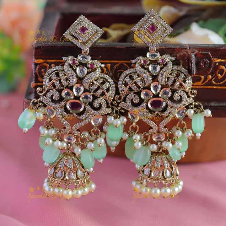 Gracious Dual tone Peacock carved Victorian AD earrings with jhumuka hanging - Sparkle and Glow