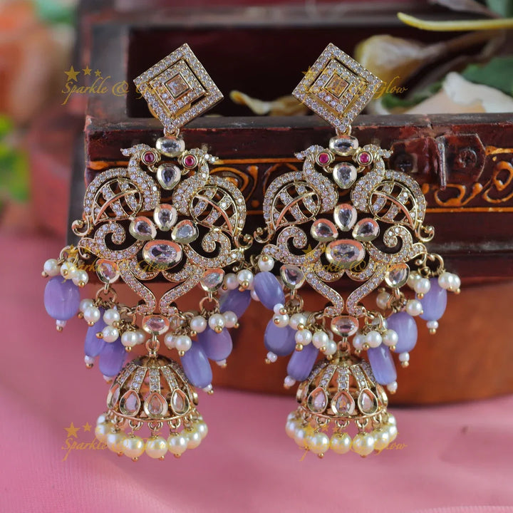 Gracious Dual tone Peacock carved Victorian AD earrings with jhumuka hanging - Sparkle and Glow