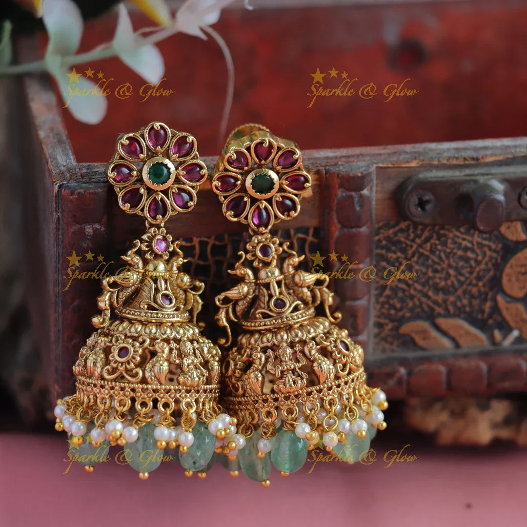 Grand Kemp Floral Studded Idol Lakshmi peacock carved jhumukas with mintgreen beads - Sparkle and Glow