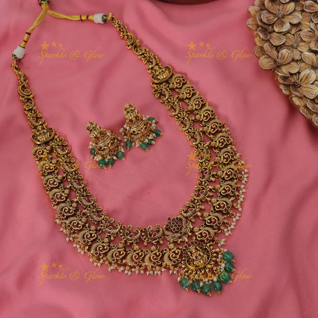 Grand intricate Lakshmi peacock carved long necklace with ruby emerald pearls and green beads - Sparkle and Glow