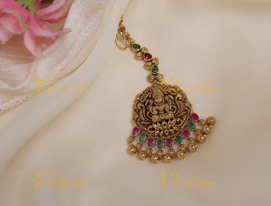 Sparkling Idol Lakshmi carved single line maangtikka with gold beads - Sparkle and Glow